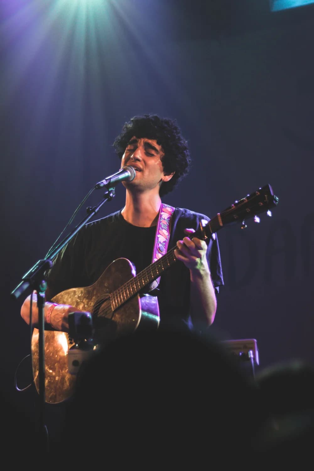 Concert photo shot by Liz of a musician playing guitar on stage